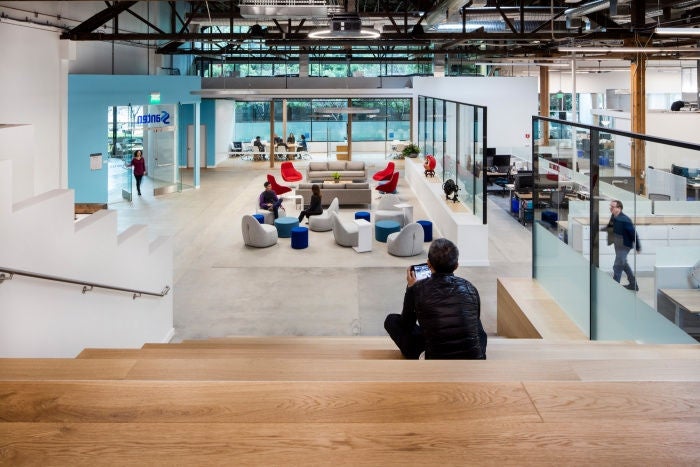 A view of the Santen USA office that shows collaboration meeting spaces and ergonomic workstations in an open space well-lit with natural lighting.