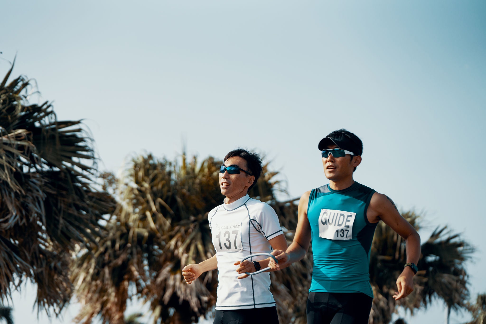 Blind triathlete running and training with his guide