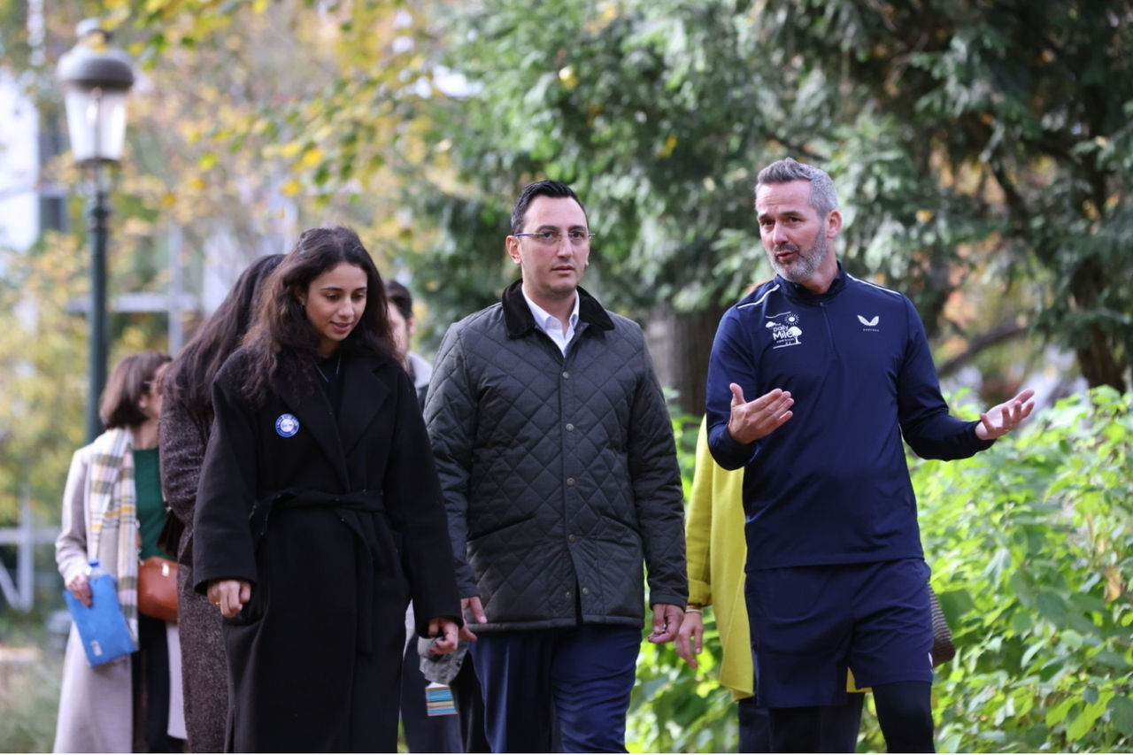 A photo of Nadiya talking with EU policymakers while walking on Outdoor Classroom Day