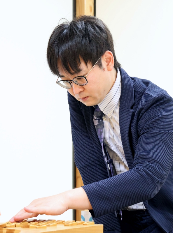 A photo of Takayuki playing shogi 