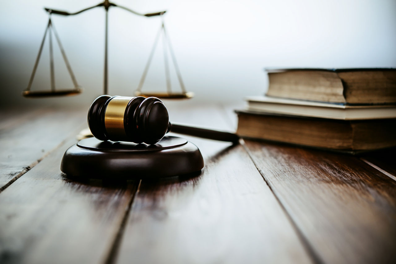 Law theme, mallet of the judge, law enforcement officers, evidence-based cases, and documents taken into account.